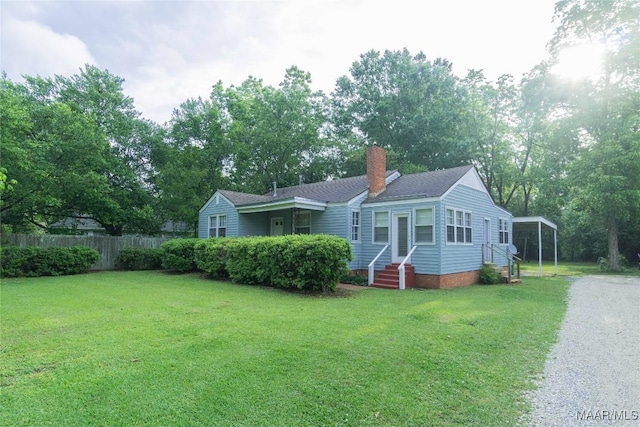 view of front of property with a carport and a front yard