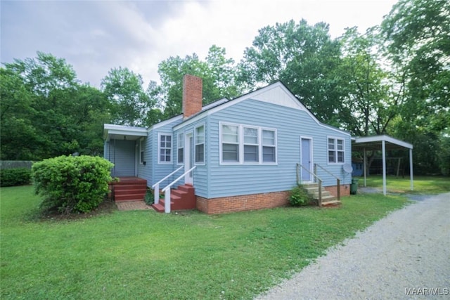 view of front facade with a carport and a front yard