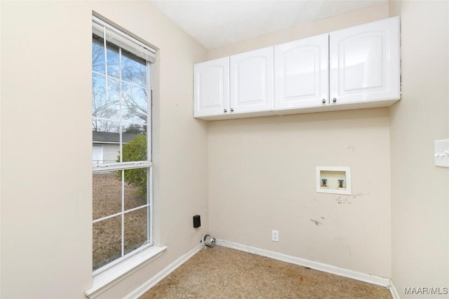 clothes washing area featuring hookup for a washing machine and cabinets