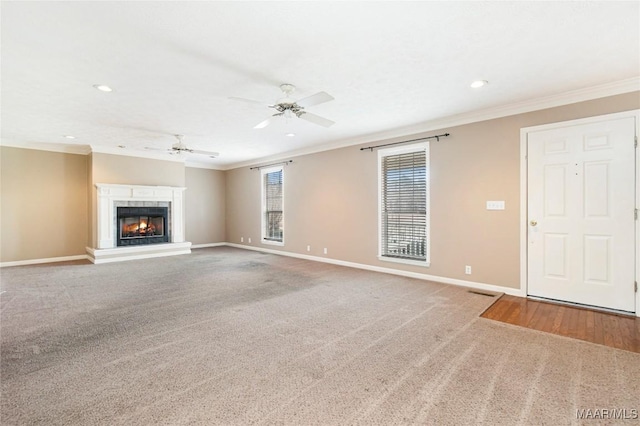 unfurnished living room featuring crown molding, carpet flooring, and ceiling fan