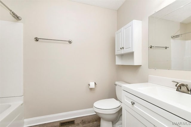 full bathroom with washtub / shower combination, vanity, toilet, and hardwood / wood-style floors