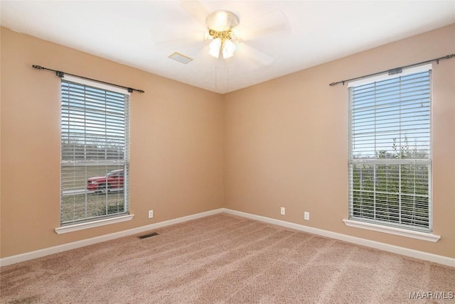 unfurnished room featuring ceiling fan and carpet floors