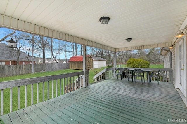 deck featuring a lawn and a storage shed