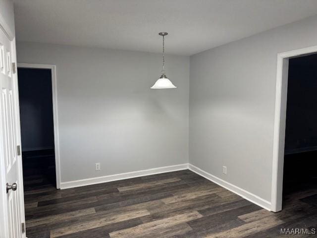 unfurnished dining area featuring dark hardwood / wood-style floors