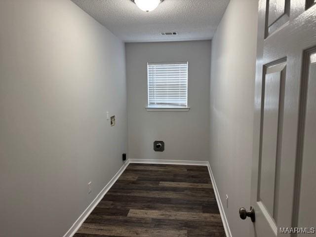 laundry room featuring dark wood-type flooring, hookup for an electric dryer, and a textured ceiling