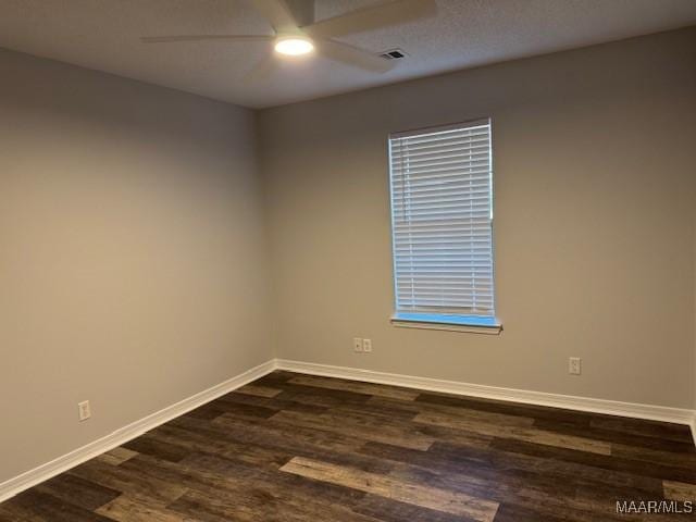 empty room featuring dark hardwood / wood-style floors and ceiling fan