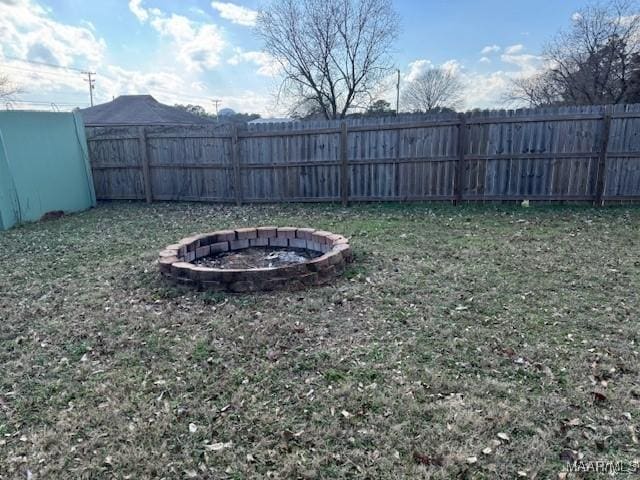 view of yard with a fire pit