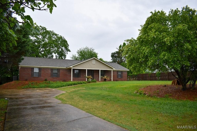 6515 Redland Rd, Wetumpka, AL 36093 - ranch-style home featuring brick siding, fence, concrete driveway, a porch, and a front lawn
