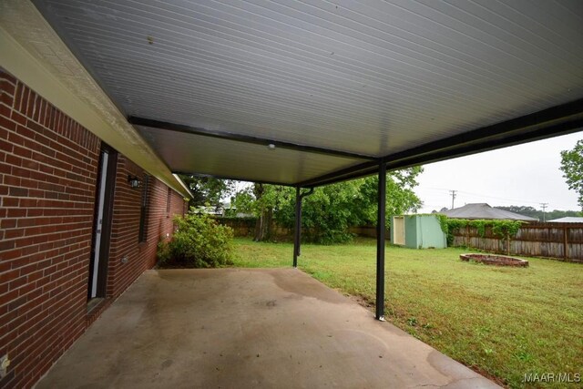 6515 Redland Rd, Wetumpka, AL 36093 - view of patio with a fenced backyard, a storage unit, and an outbuilding