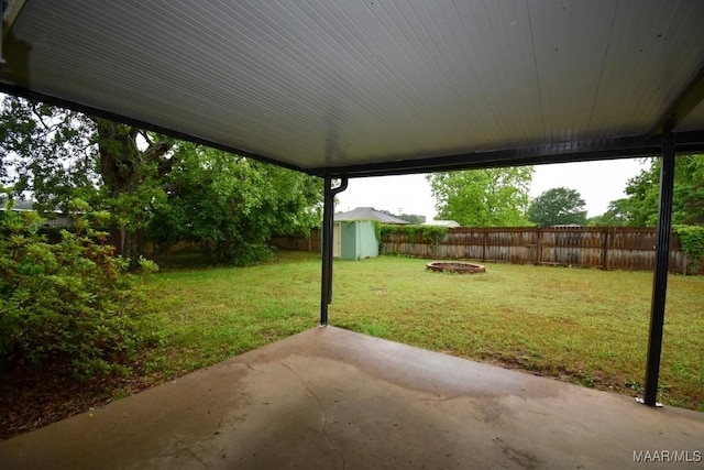 6515 Redland Rd, Wetumpka, AL 36093 - view of yard with an outdoor structure, an outdoor fire pit, a patio area, a fenced backyard, and a storage unit