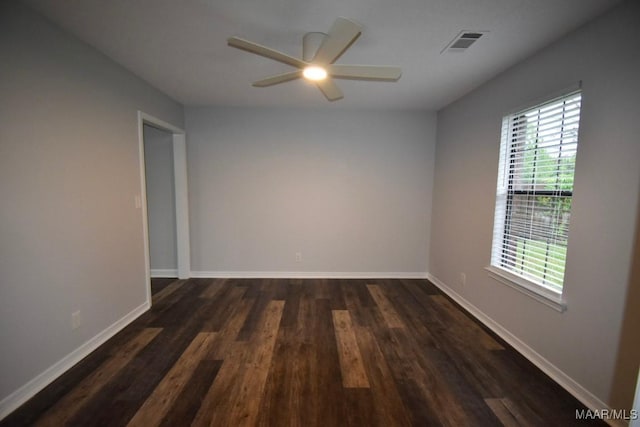 6515 Redland Rd, Wetumpka, AL 36093 - spare room featuring a healthy amount of sunlight, a ceiling fan, visible vents, and dark wood-type flooring