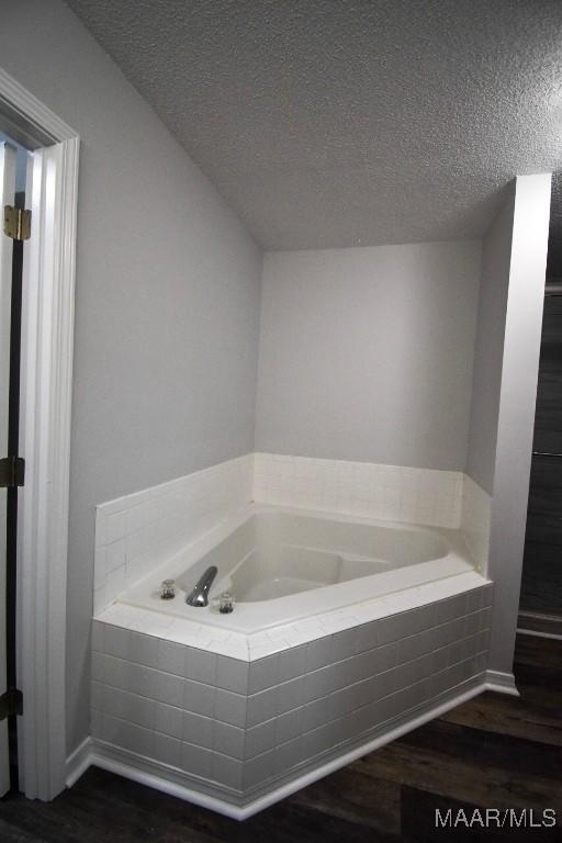 6515 Redland Rd, Wetumpka, AL 36093 - full bath featuring a textured ceiling, a bath, and wood finished floors