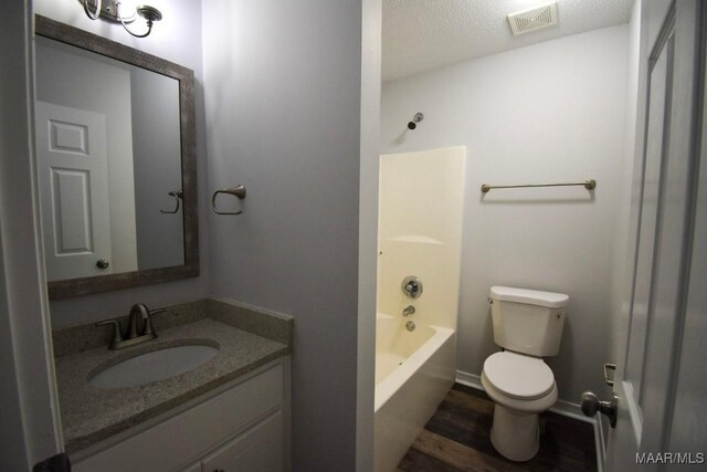 6515 Redland Rd, Wetumpka, AL 36093 - full bath with toilet, wood finished floors, shower / tub combination, visible vents, and vanity