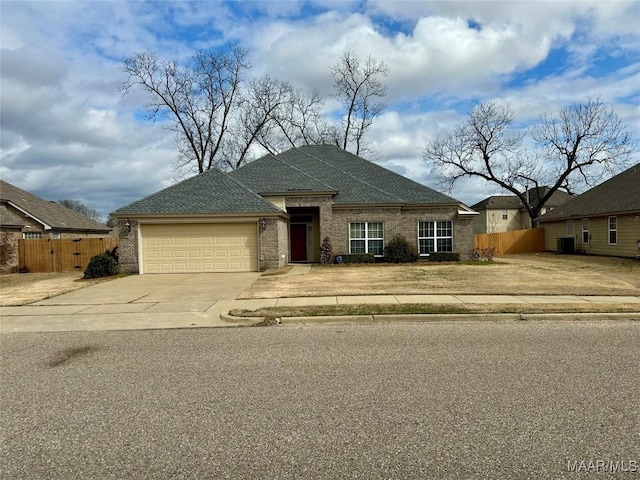 view of front of house with a garage and central air condition unit