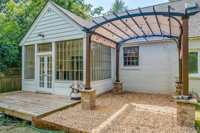 exterior space with french doors and a pergola