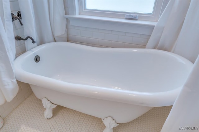 bathroom featuring a bath and tile patterned floors