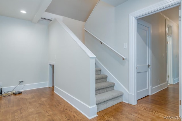 staircase with hardwood / wood-style flooring