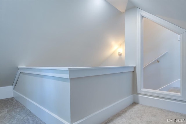 interior space featuring lofted ceiling and light colored carpet