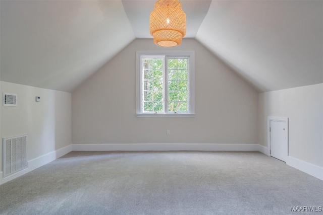 additional living space with vaulted ceiling and light colored carpet