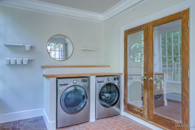 washroom with crown molding, plenty of natural light, washer and dryer, and french doors