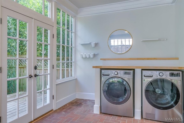 laundry area with french doors, crown molding, and washer and dryer