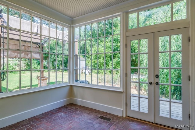 unfurnished sunroom with french doors