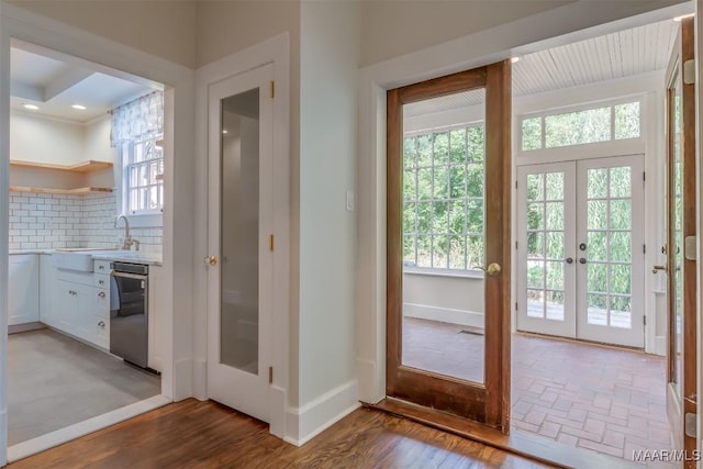 doorway to outside with plenty of natural light, sink, dark hardwood / wood-style flooring, and french doors