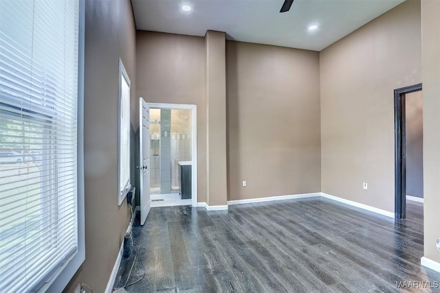 spare room featuring dark hardwood / wood-style flooring and ceiling fan