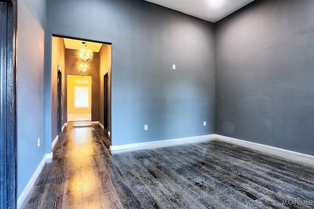 empty room with dark hardwood / wood-style flooring