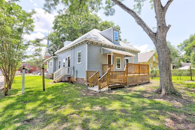 view of front of property with a wooden deck and a front lawn