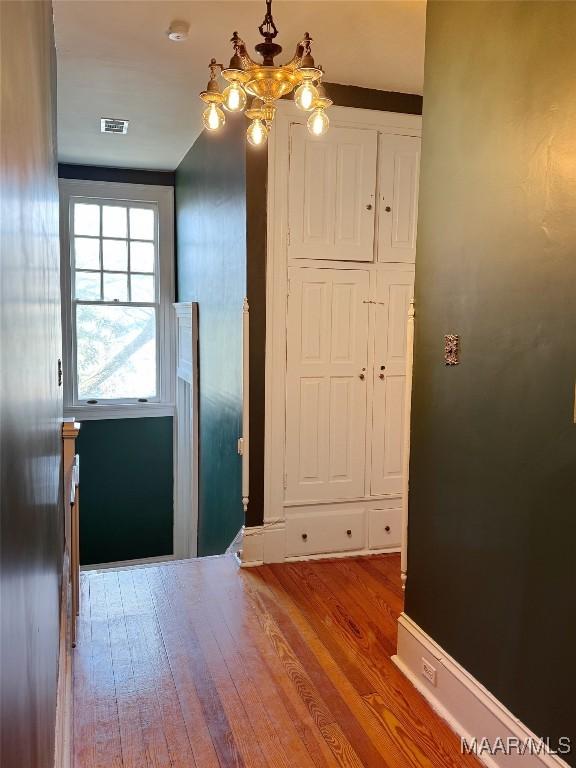 interior space with hardwood / wood-style flooring and a chandelier