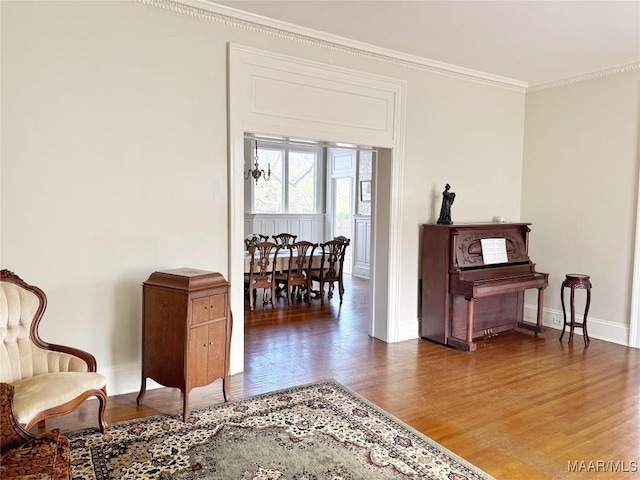 living area featuring ornamental molding and wood-type flooring