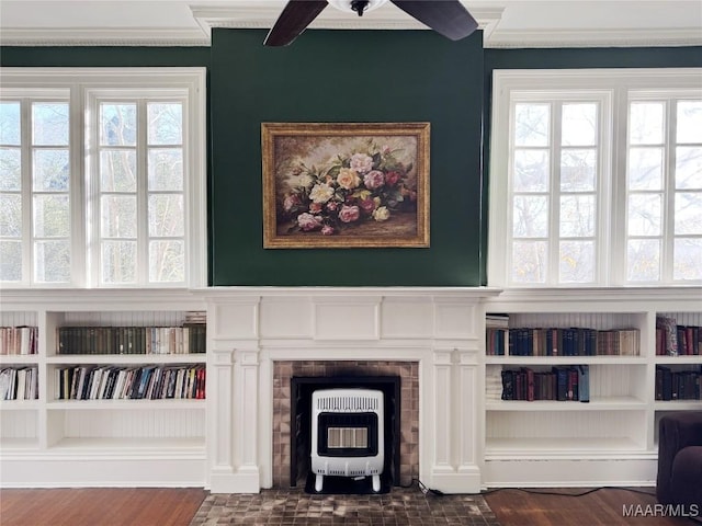 interior space with dark wood-type flooring, heating unit, and built in features