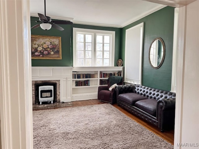 sitting room featuring ornamental molding, dark hardwood / wood-style floors, and ceiling fan