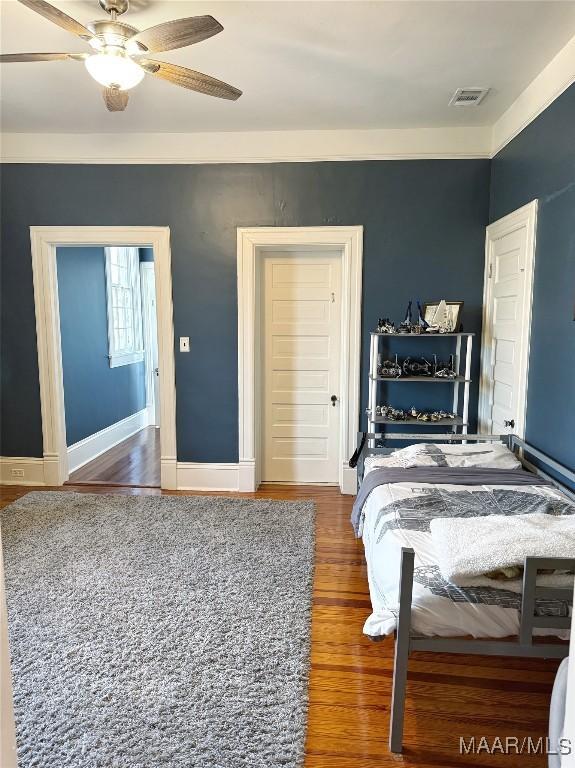 bedroom featuring dark wood-type flooring and ceiling fan