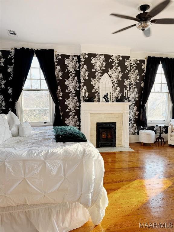 bedroom with hardwood / wood-style flooring and ceiling fan