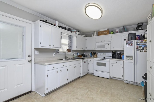 kitchen featuring sink, white cabinets, and white appliances