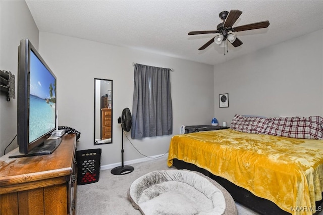 bedroom featuring ceiling fan, carpet floors, and a textured ceiling