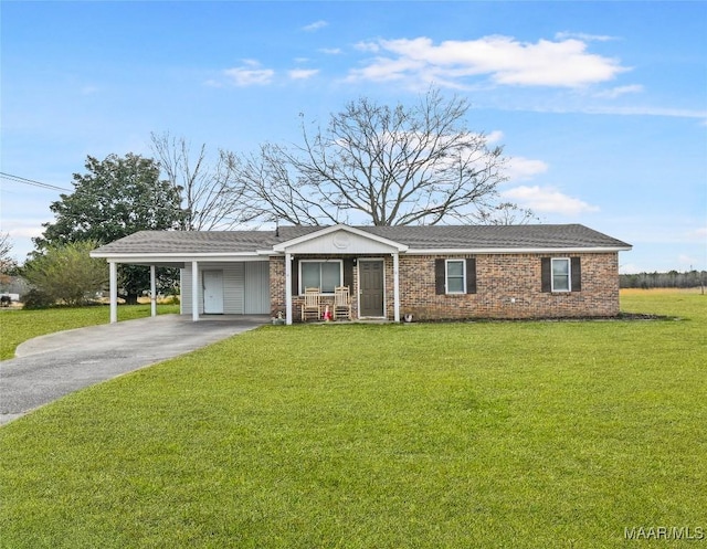 ranch-style house featuring a front yard and a carport