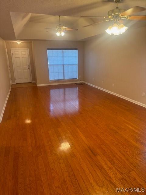 spare room with hardwood / wood-style flooring, a textured ceiling, and ceiling fan