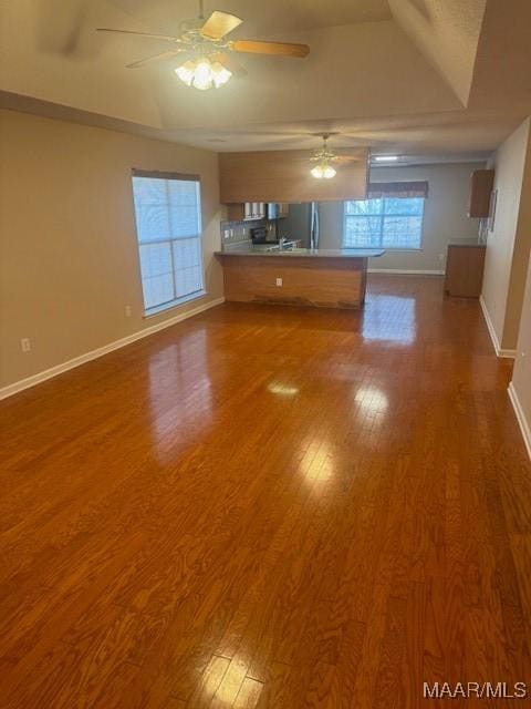 unfurnished living room with ceiling fan and wood-type flooring