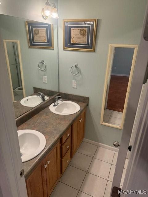 bathroom featuring double vanity, a sink, and tile patterned floors