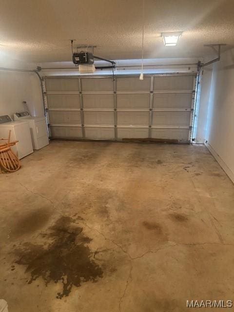 garage with a garage door opener and washing machine and dryer