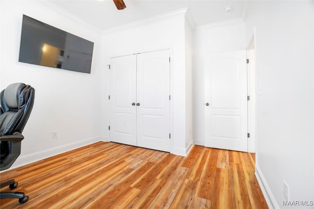 unfurnished office with ceiling fan, ornamental molding, and light hardwood / wood-style floors