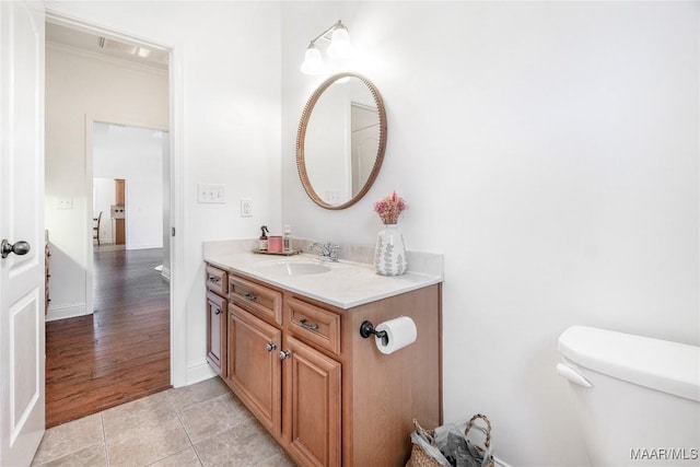 bathroom featuring vanity, tile patterned floors, and toilet