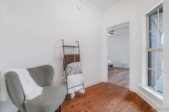 living area featuring ornamental molding and wood-type flooring