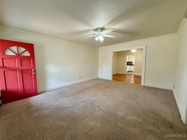 interior space with crown molding, carpet floors, and ceiling fan