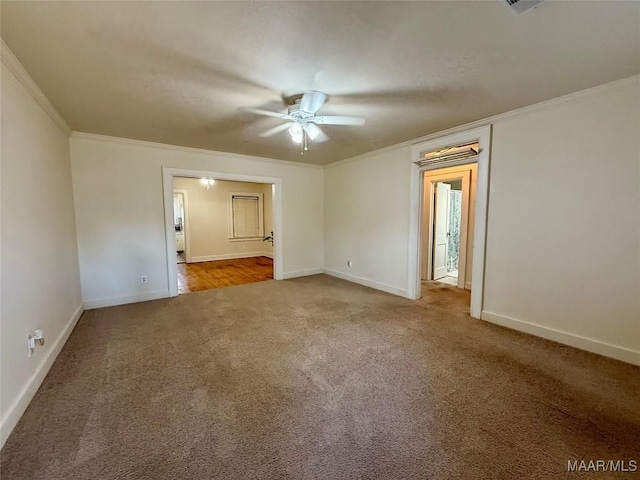 empty room featuring ornamental molding, ceiling fan, and carpet