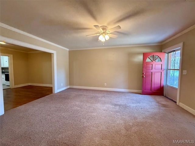 interior space featuring ornamental molding, carpet flooring, and ceiling fan