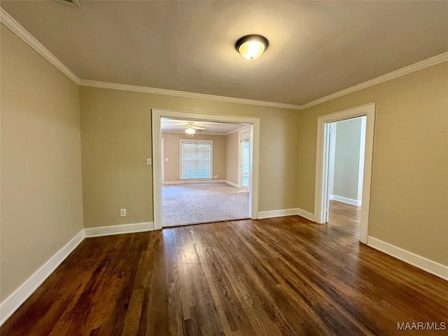 unfurnished room featuring dark wood-type flooring and ornamental molding